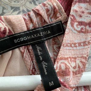 Beautiful and feminine cold shoulder top with ties at cuff of blouse.